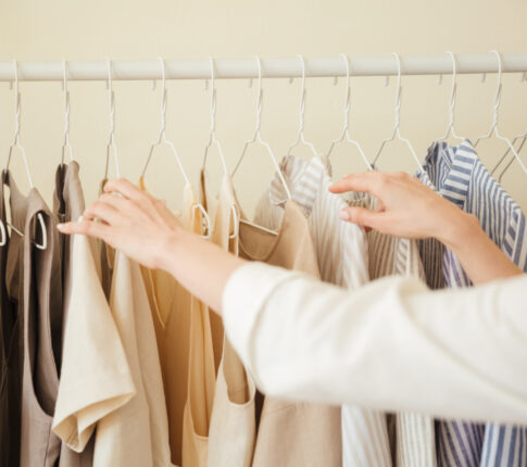 Close up of clothes hanging on rack